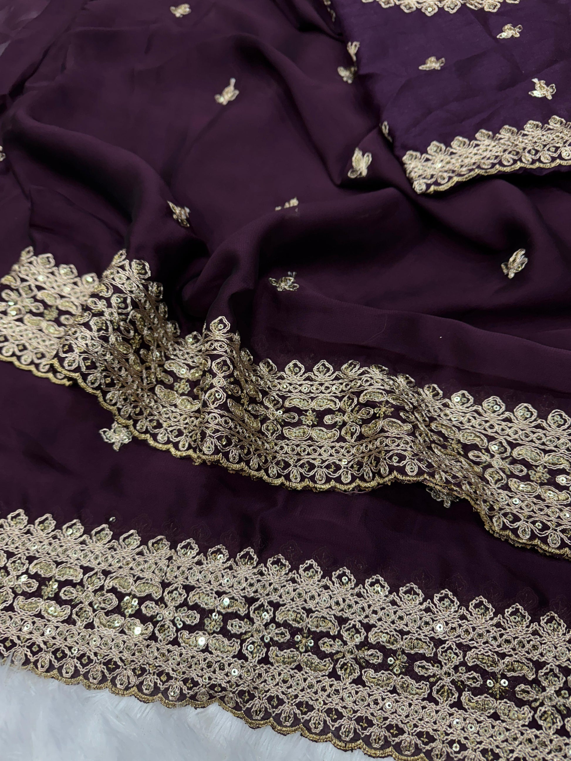 Close-up of wine Rangoli silk fabric texture with intricate sequins and dori embroidery - WishTown Fashion Club