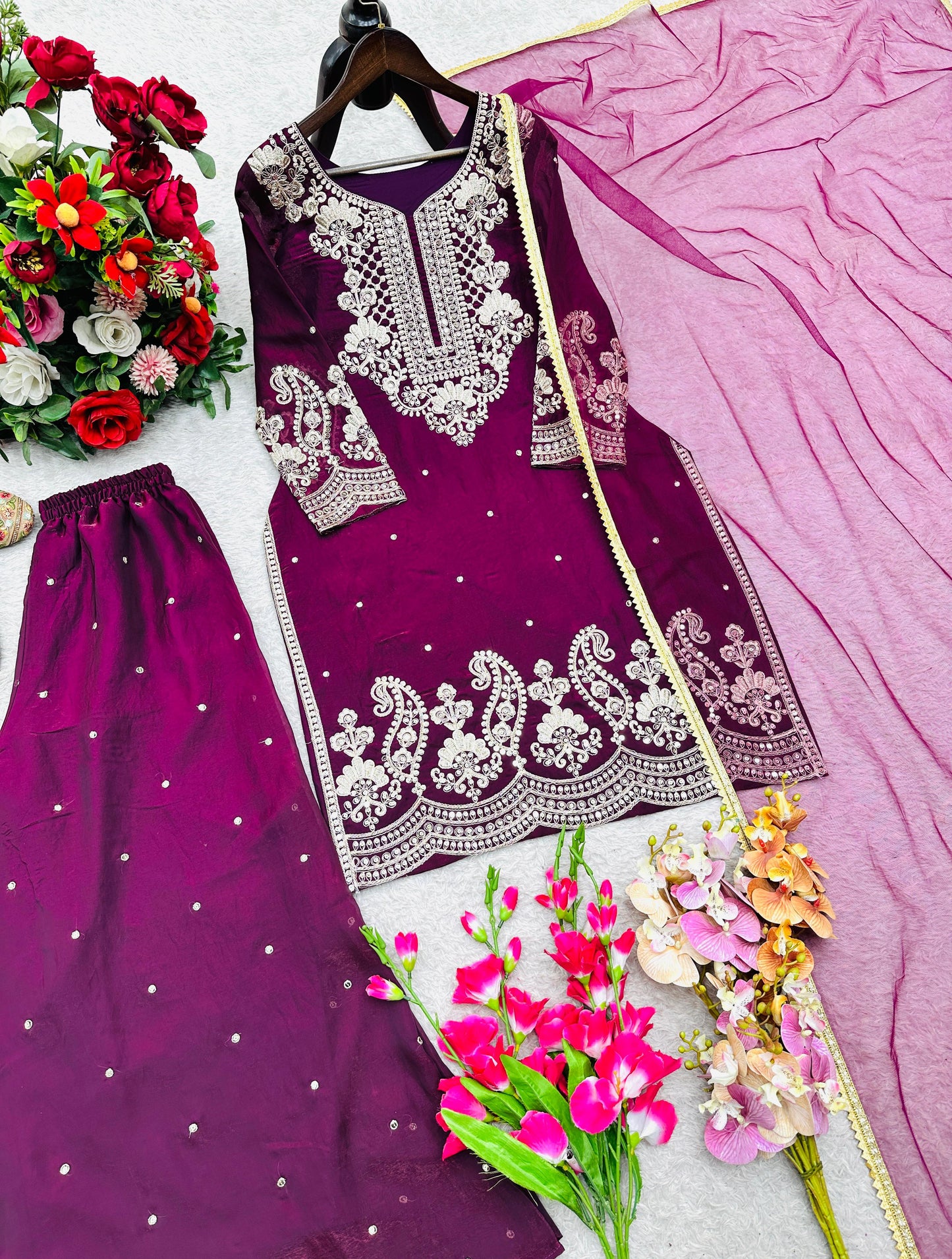Purple ethnic women's dress set with intricate white embroidery, matching pants, dupatta, and floral accents by WishTown Fashion Club®
