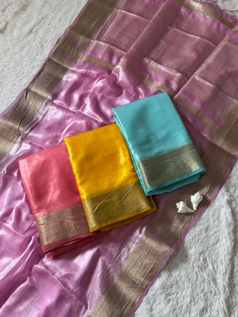 Assorted Space Silk sarees in yellow, pink, peach pink and sky blue shades showcasing soft shine fabric with pure zari borders and pallu designs – WishTown Fashion Club