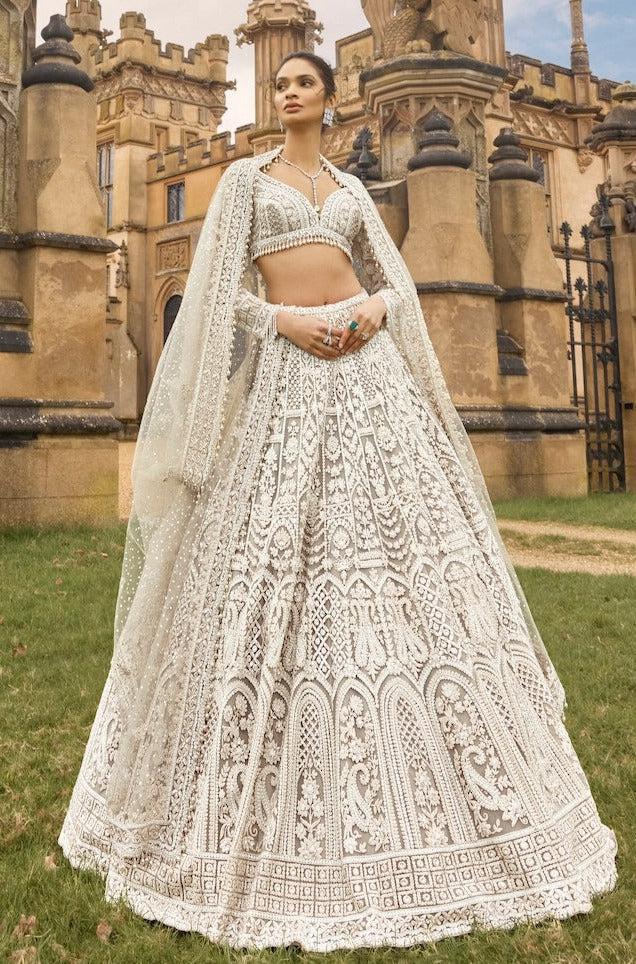 White net lehenga with sequins dori and thread embroidery front view - WishTown Fashion Club