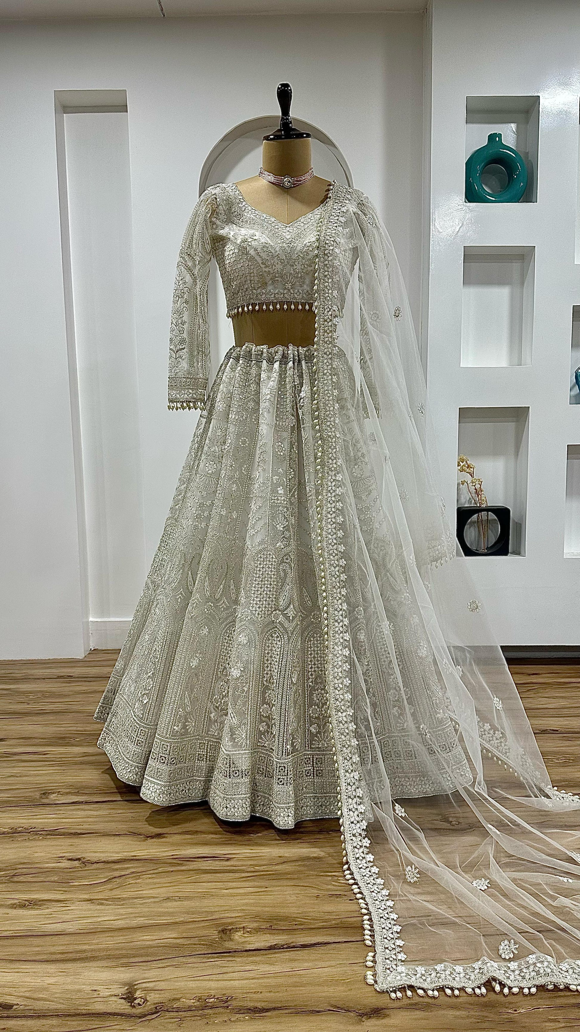 White festive wear lehenga set detailed embroidery and pearl border work - WishTown Fashion Club