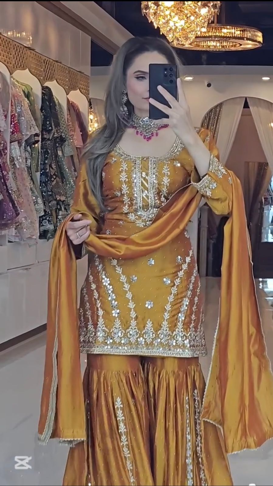 Mustard yellow Chinnon silk sharara suit with fully flared plazo and embroidered dupatta side view - WishTown Fashion Club