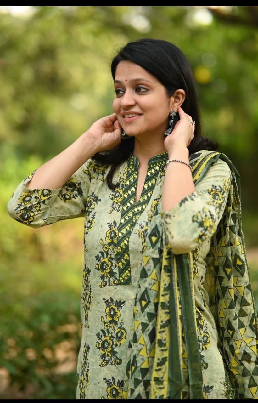 green printed suit with v neck kurta and contrast striped pants elegant outfit - WishTown Fashion Club