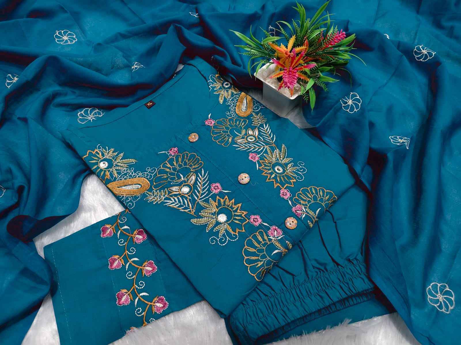 Side perspective presentation of the fully stitched teal blue ethnic tunic highlighting the clean tailored seams and forty four plus inch regular fit length.