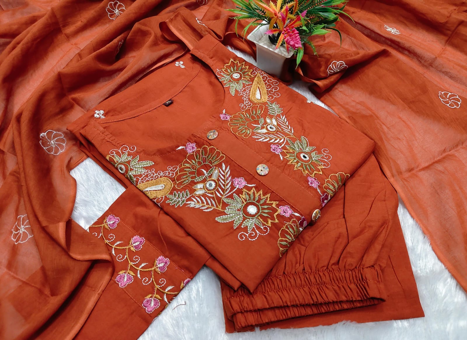 Side perspective presentation of the fully stitched rust orange ethnic tunic highlighting the clean tailored seams and forty four plus inch regular fit length.