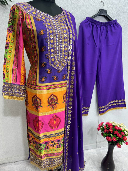 Close up view of vivid multi color floral digital prints and shimmering embroidered sequence work details on a deep purple faux georgette cloth surface.