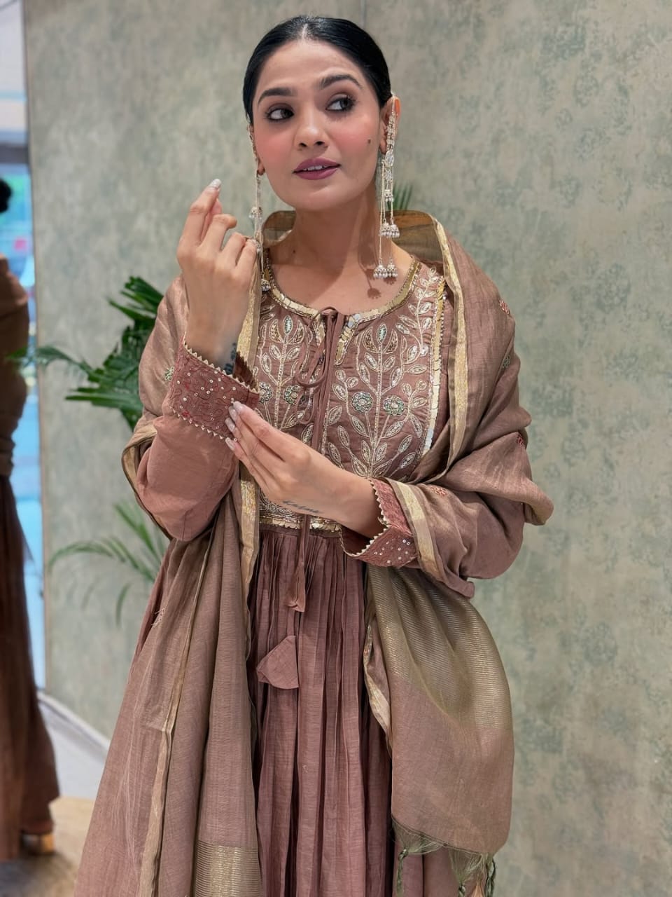 Back angle presentation of a fully stitched rosy brown traditional outfit highlighting the clean tailoring and premium material texture.