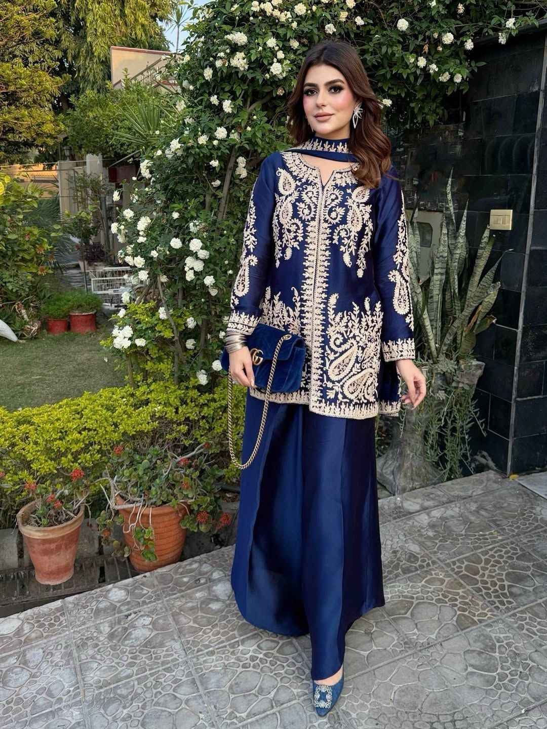 Front view of full three piece navy blue traditional festive outfit featuring an embroidered silk tunic top and wide leg palazzo trousers.