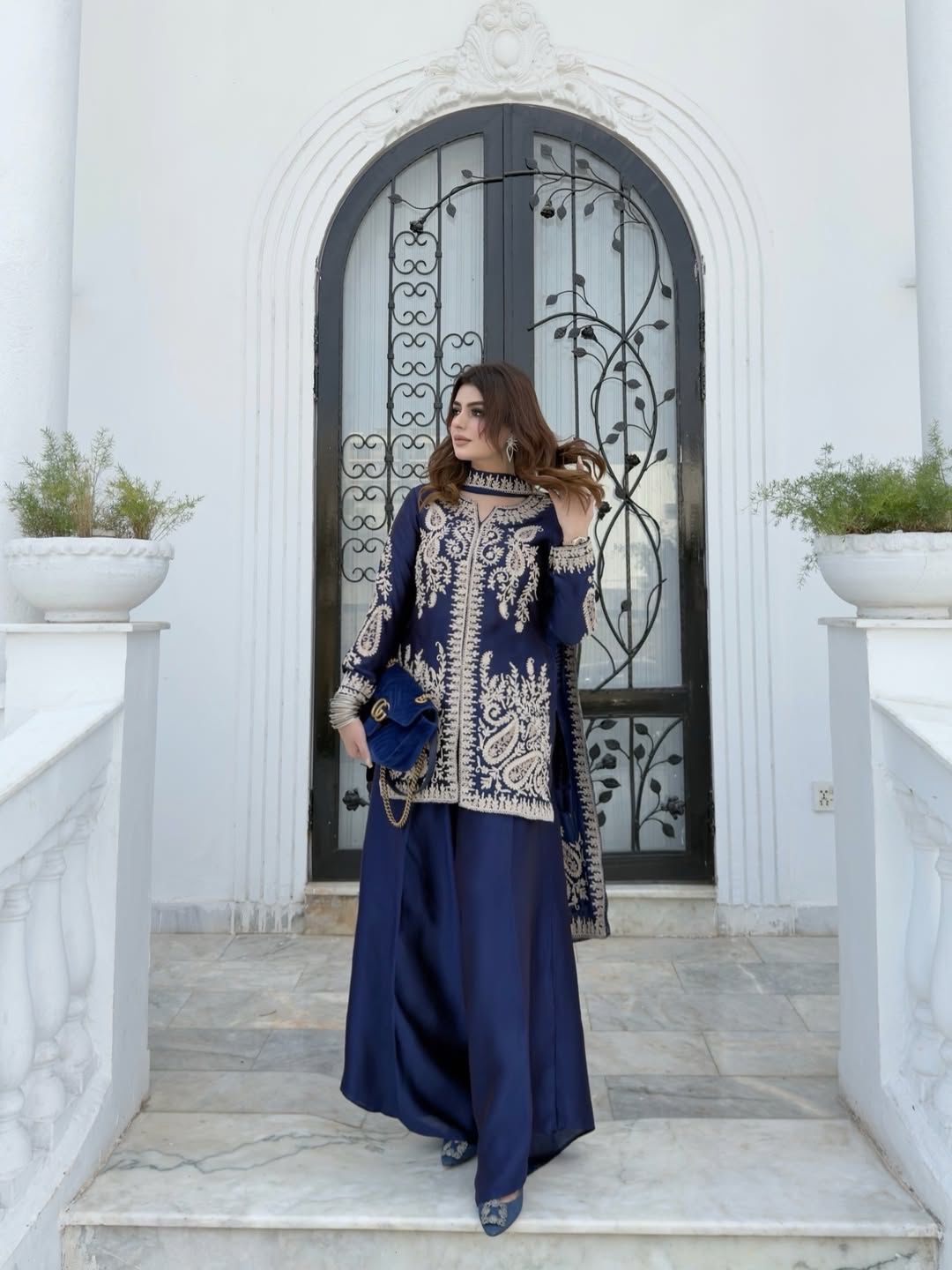 Flat layout display of the designer navy blue ethnic set highlighting the three component pieces including top pants and long scarf.