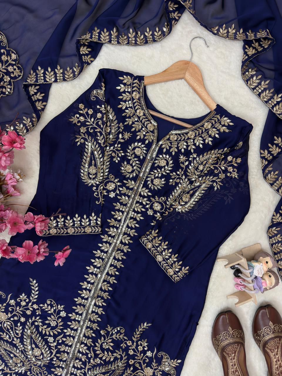 Macro view of the premium textile surface showing high quality weaving patterns and structural shine of navy blue rangoli silk material.