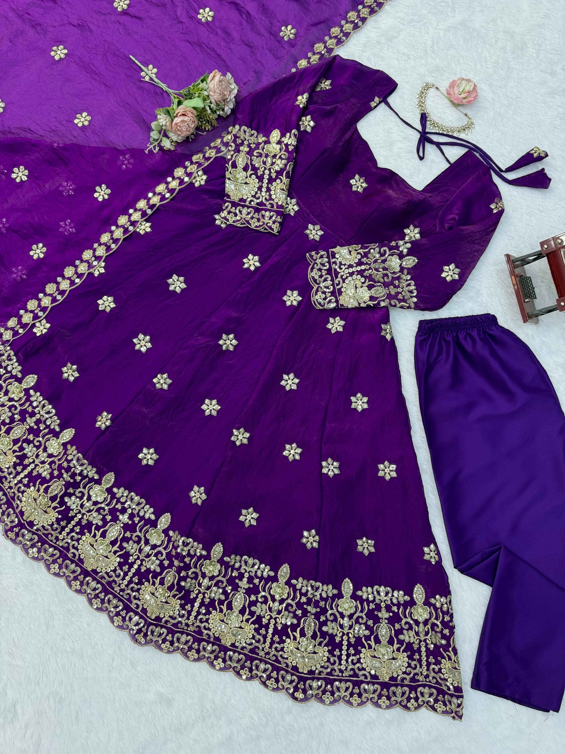 Detailed shot of intricate thread patterns and glittering three millimeter and nine millimeter sequins on a deep purple fendy silk bodice.