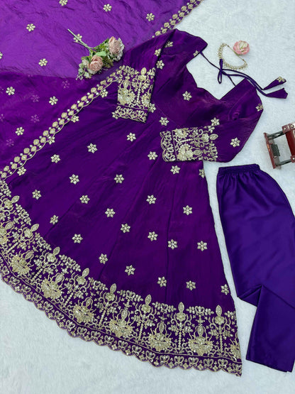 Detailed shot of intricate thread patterns and glittering three millimeter and nine millimeter sequins on a deep purple fendy silk bodice.