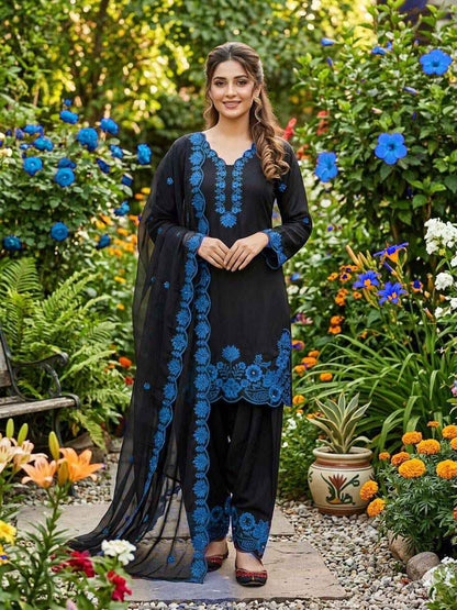 Side profile view of a blue traditional ensemble showcasing the lightweight semi transparent drape of the premium organza dupatta.