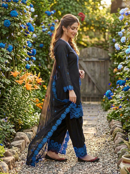 Front view of a rich royal blue traditional three piece suit displaying an embroidered long tunic top and relaxed farsi trousers.