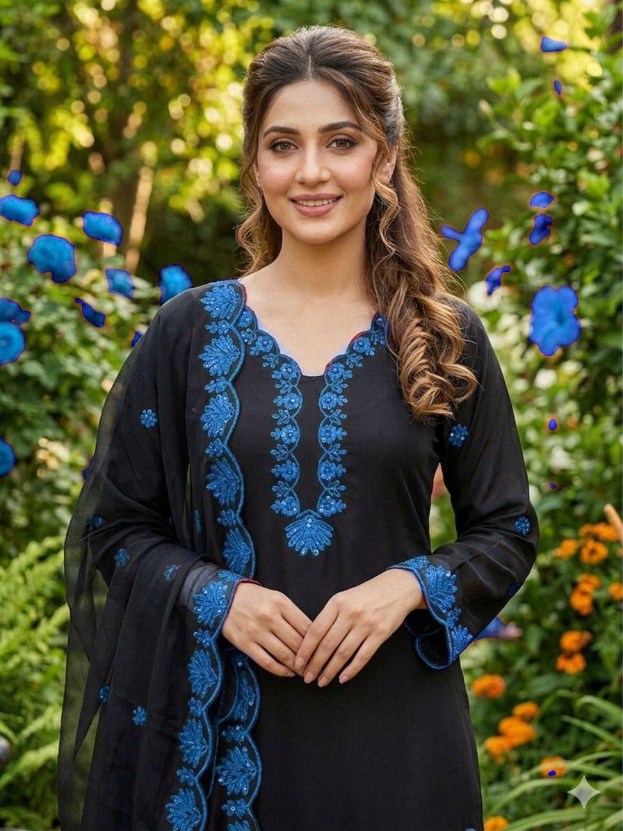 Focused shot of beautiful artisan sequence embroidery patterns on deep royal blue crape silk material near the neckline.