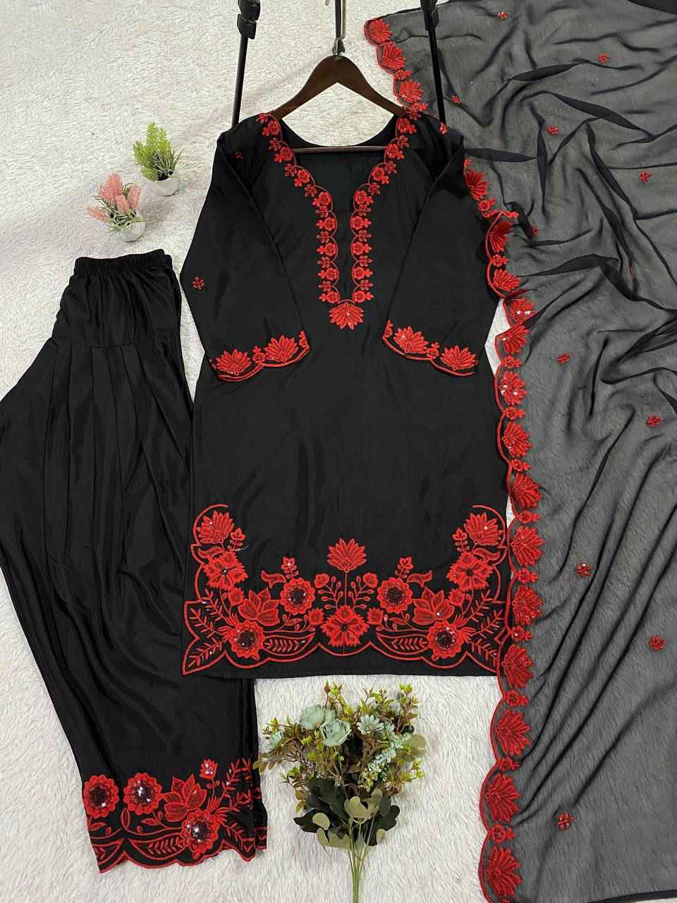 Close up view of detailed traditional sequence embroidery work on the luxurious smooth surface of a crimson red crape silk bodice.