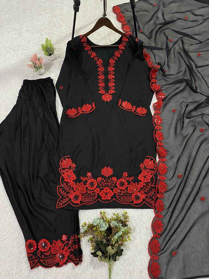 Close up view of detailed traditional sequence embroidery work on the luxurious smooth surface of a crimson red crape silk bodice.