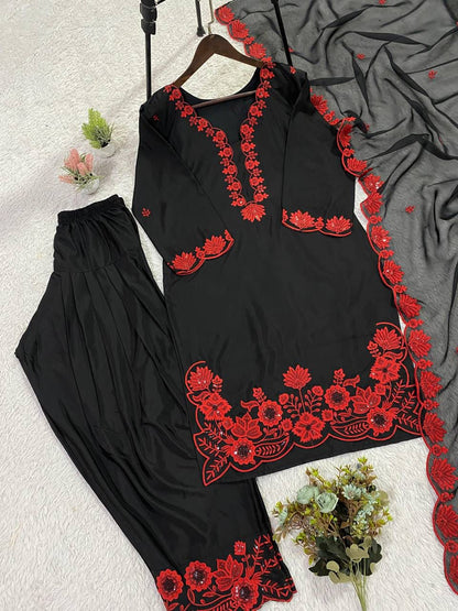 Side perspective of a fully stitched red traditional outfit showcasing the sheer soft organza dupatta with shimmering border detailing.