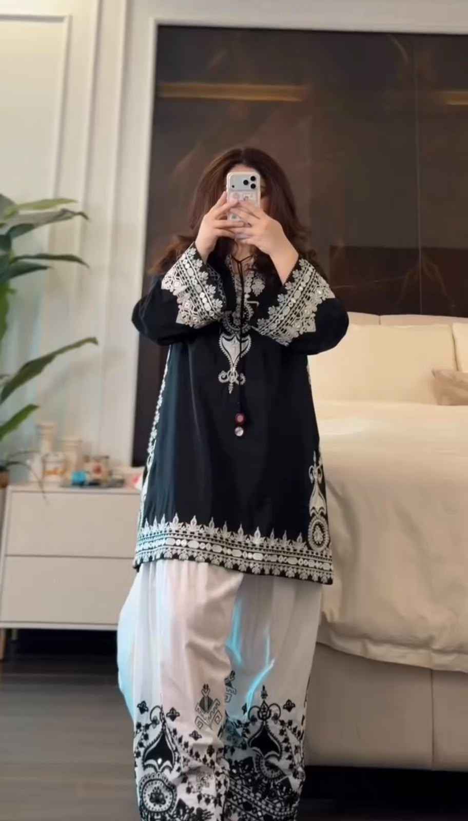Front view of full three piece black traditional festive outfit displaying an embroidered pure natural crepe silk tunic and wide leg farshi trousers.