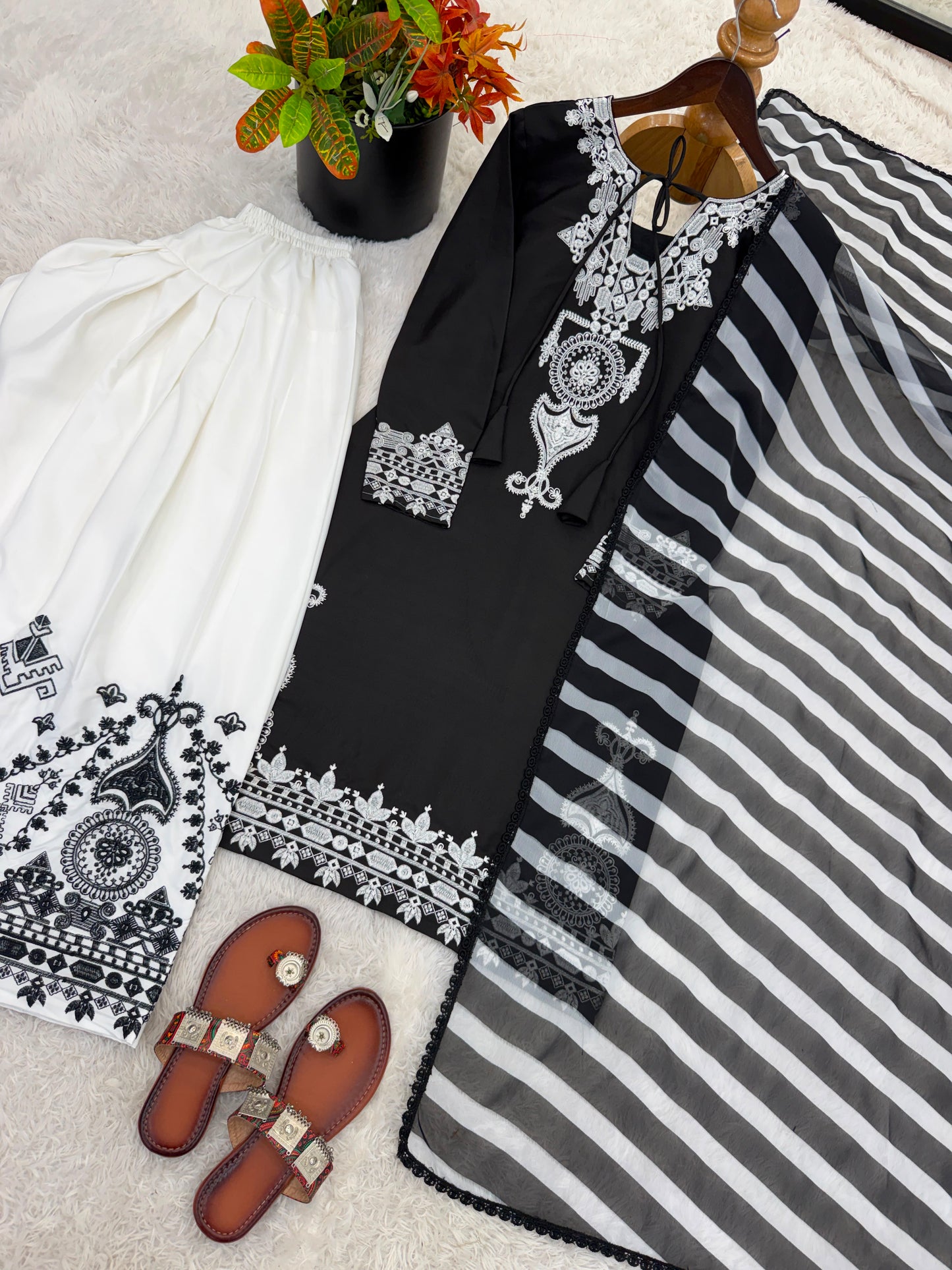 High resolution view of a black faux georgette dupatta scarf displaying vibrant multi color digital floral print details and finished borders.