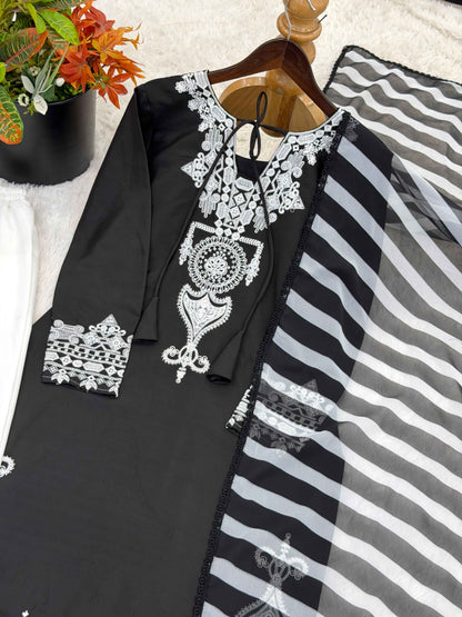 Close up view of detailed traditional embroidery work and fine stitching patterns on the luxurious smooth surface of a black crepe silk bodice.