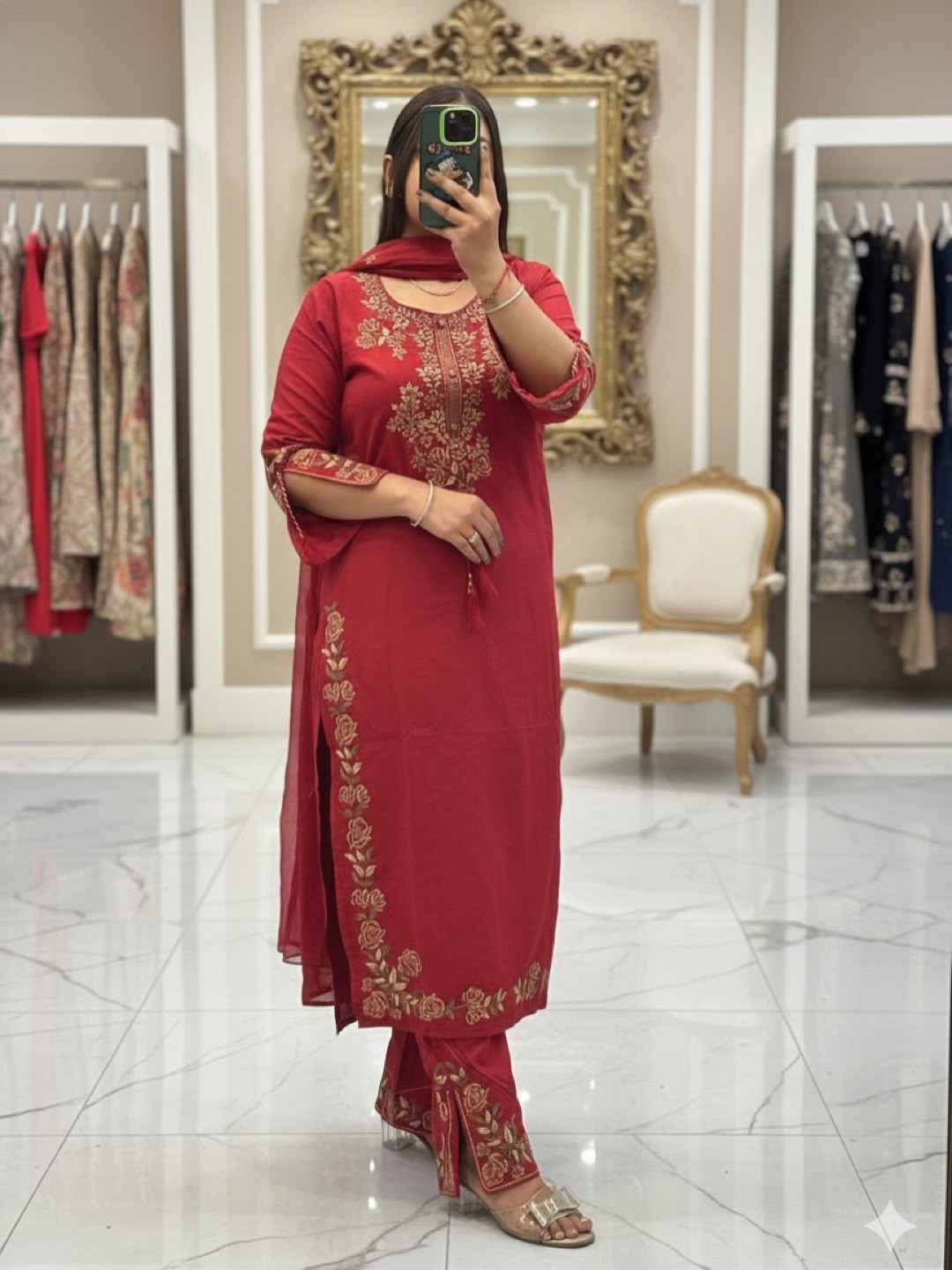 Front view of a dark maroon red festive wedding outfit featuring a long embroidered silk tunic top and wide leg trousers.
