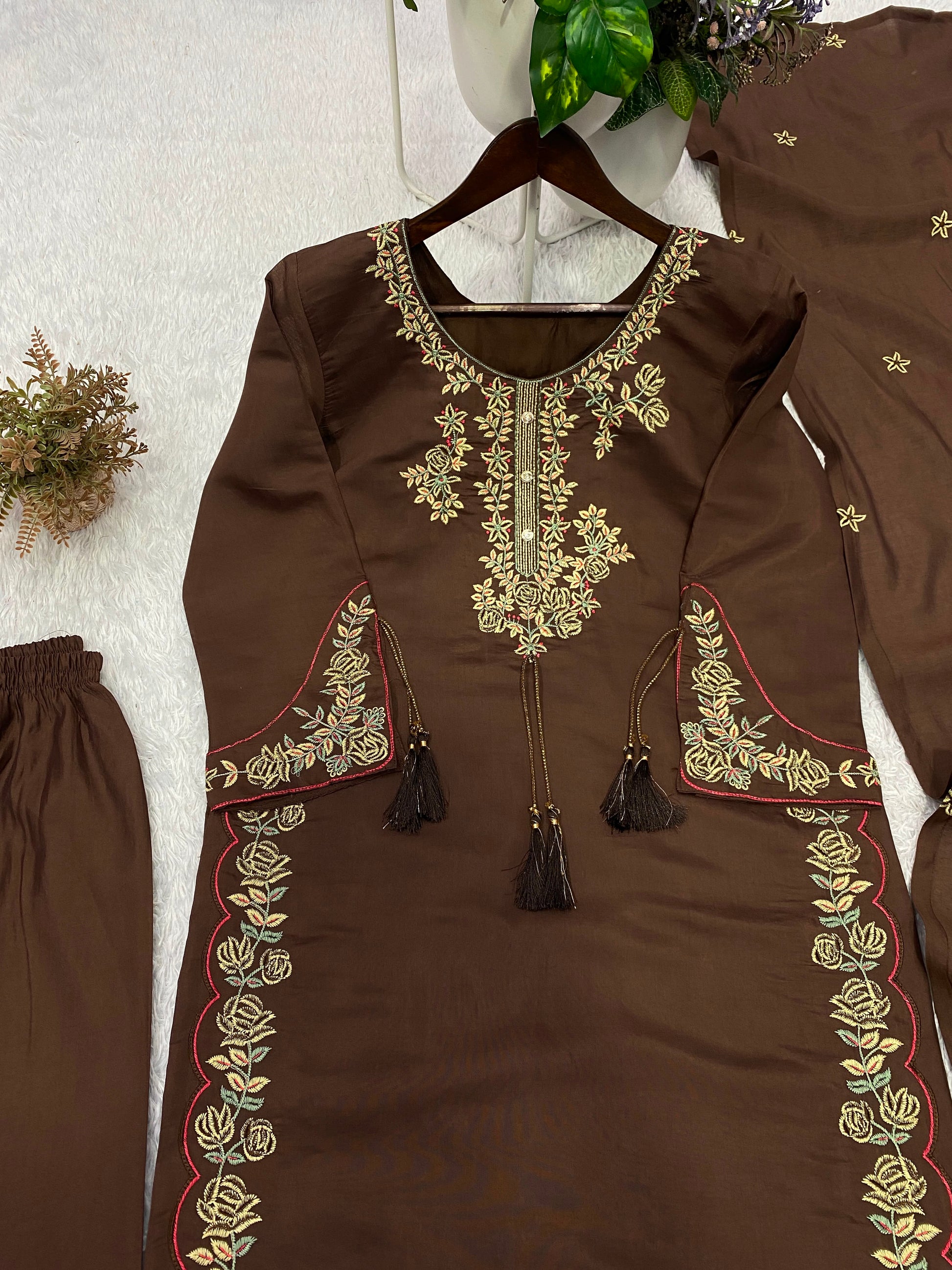 Flat layout display of a dark chocolate brown printed tunic matching trousers with embroidered borders and a long scarf.
