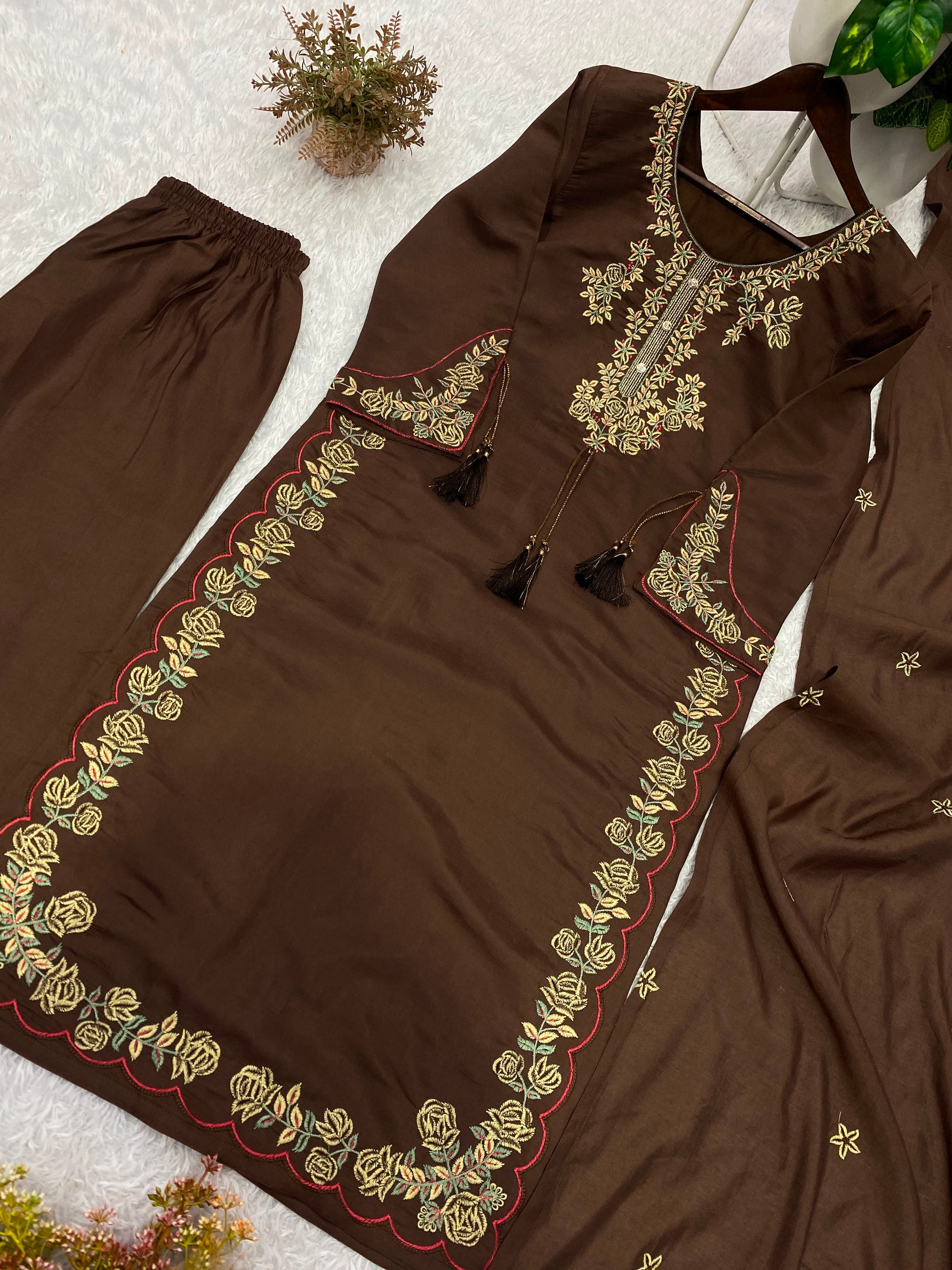 Side profile view of a chocolate brown traditional ensemble showcasing the lightweight drape of the matching premium embroidered dupatta.