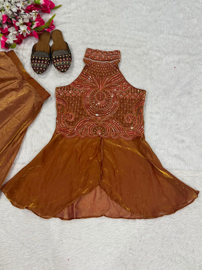 Detailed shot of the flowing brown sharara palazzo trousers displaying the tiered wide leg silhouette and premium fabric texture.