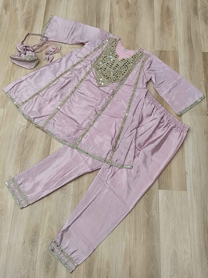 Close up view of authentic reflective real mirror work patterns and shimmering embroidered details on a soft pink neckline.