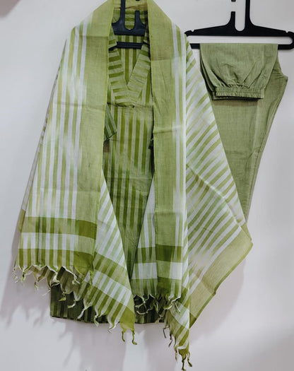 Close up view of traditional ethnic handloom south weaving patterns on a rich green cotton fabric surface.