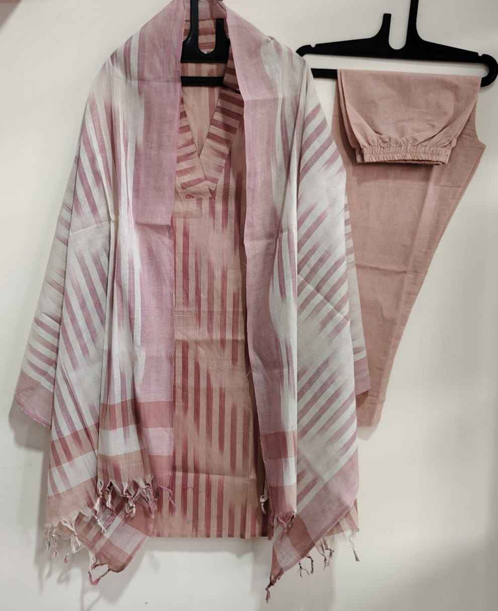 Close up view of traditional ethnic handloom south weaving patterns on an elegant dusty rose cotton fabric surface.