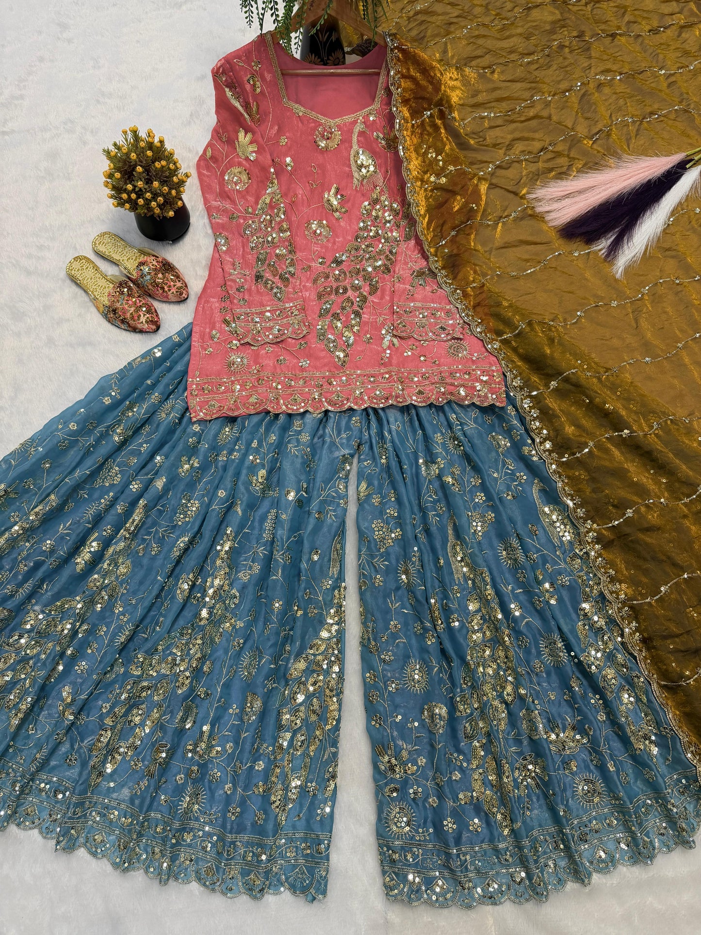 Side perspective of the fully stitched coral pink ethnic dress highlighting the elegant full length sleeves and standard tailoring lines.
