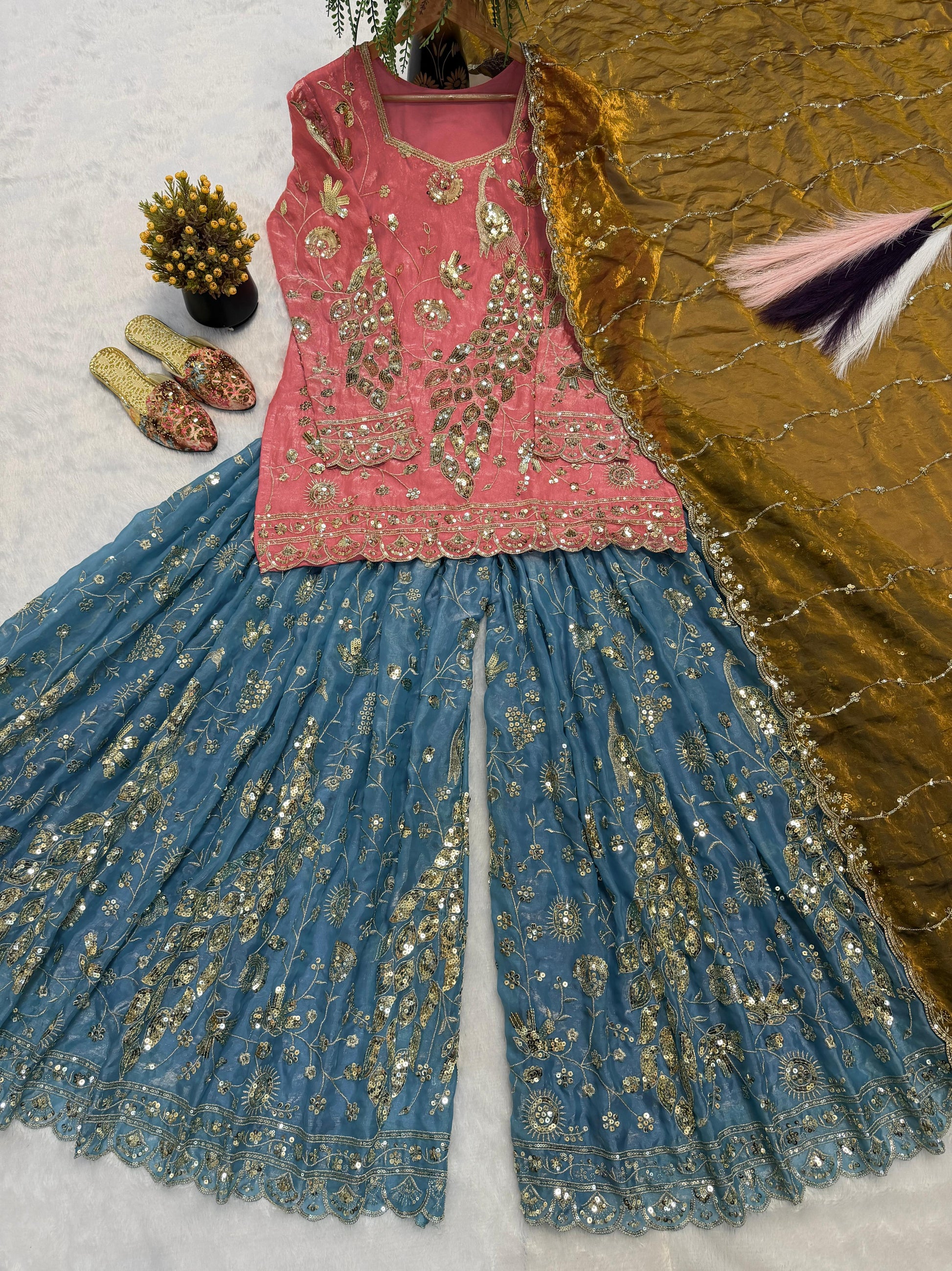 Side perspective of the fully stitched coral pink ethnic dress highlighting the elegant full length sleeves and standard tailoring lines.