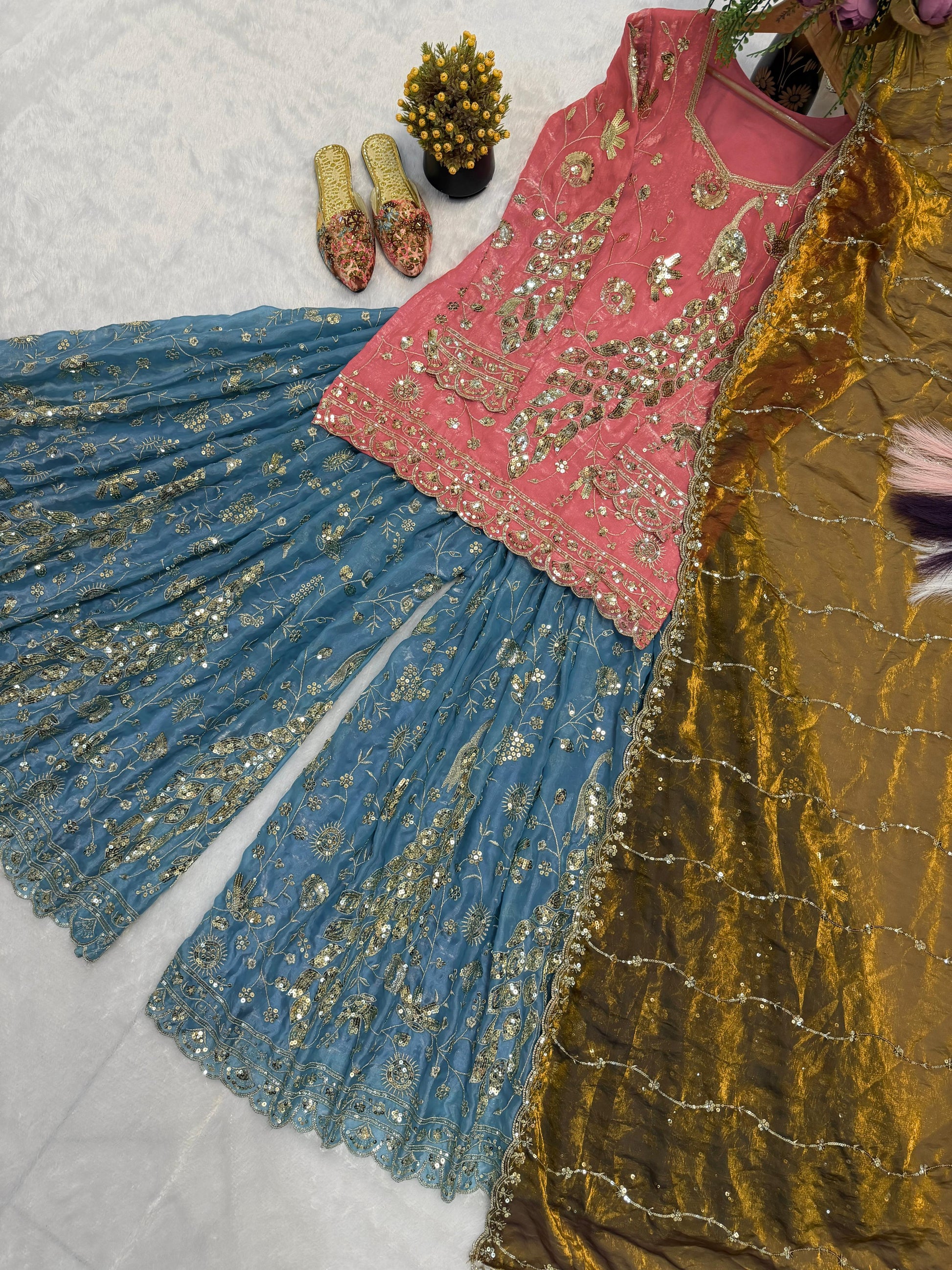 High resolution view of a coral pink crushi silk dupatta scarf displaying matching sequence borders and an elegant fancy lace trim layout.