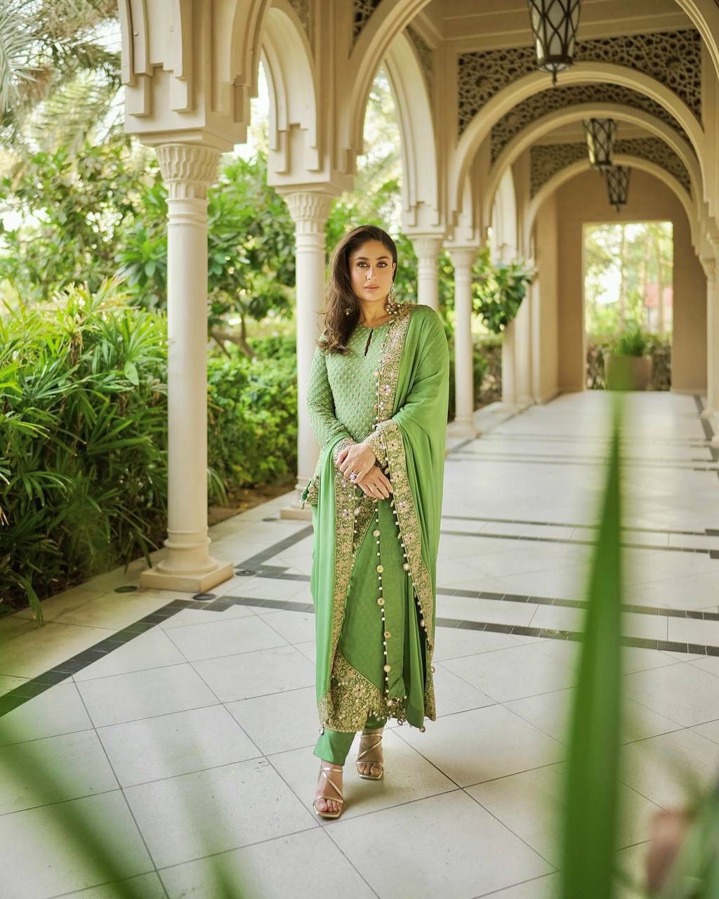 Detailed shot of the smooth green heavy butter silk palazzo pants displaying the comfortable loose fit silhouette.