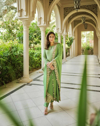 Detailed shot of the smooth green heavy butter silk palazzo pants displaying the comfortable loose fit silhouette.