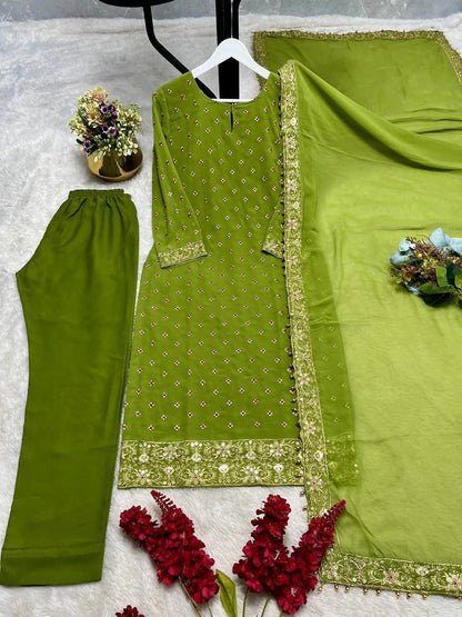 Side perspective of the fully stitched green ethnic dress highlighting the fluid georgette dupatta drape with readymade lace borders.