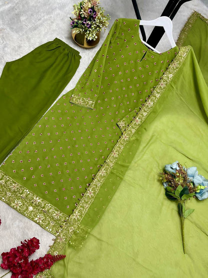 Side perspective of the fully stitched green ethnic dress highlighting the fluid georgette dupatta drape with readymade lace borders.