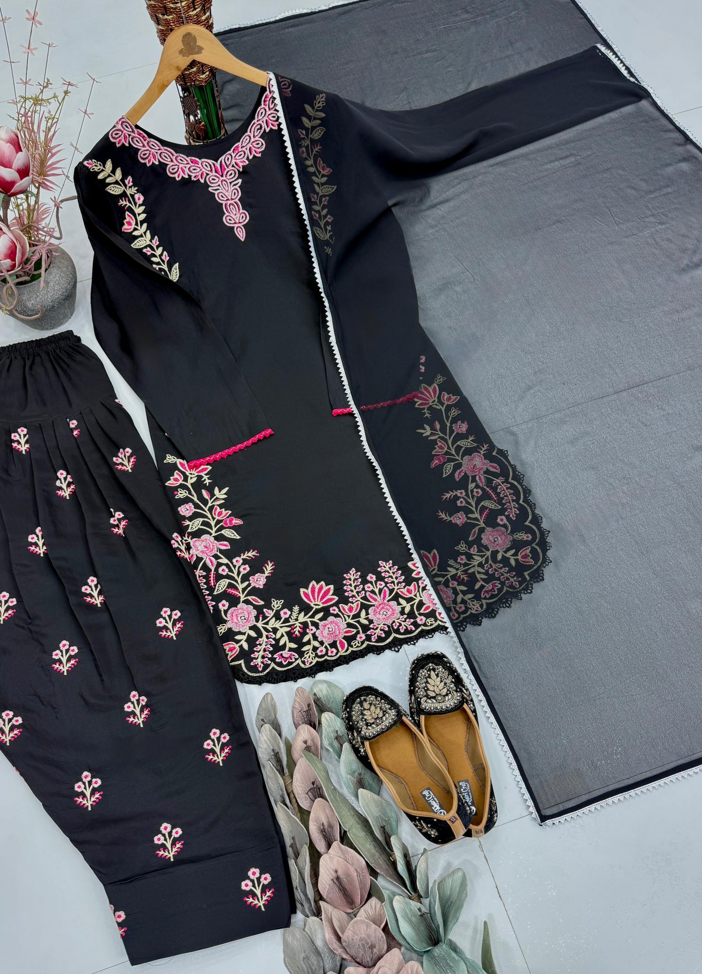 Back angle presentation of the black traditional tunic showing clean tailoring lines and a smooth seamless overall structure.