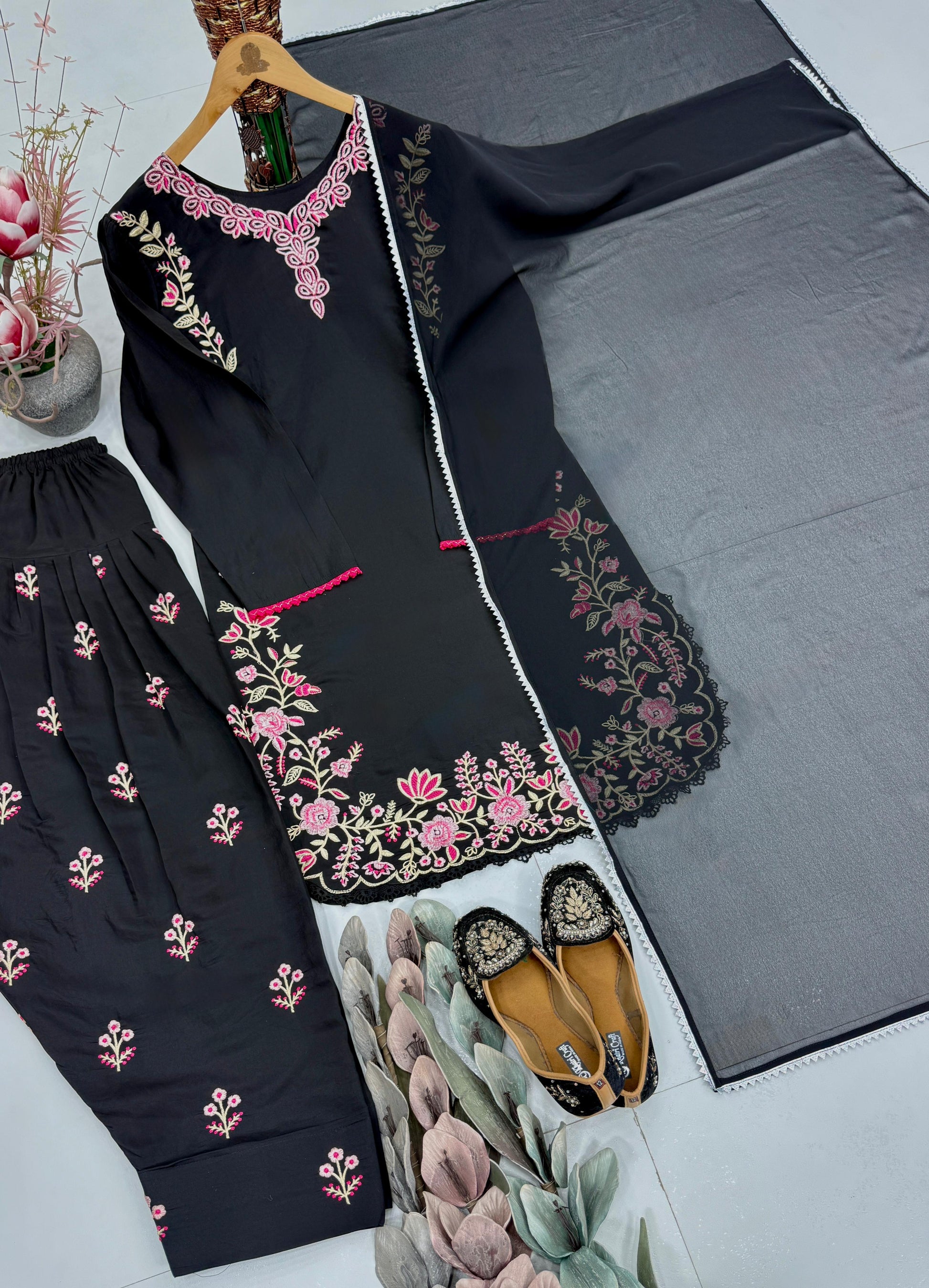 Back angle presentation of the black traditional tunic showing clean tailoring lines and a smooth seamless overall structure.