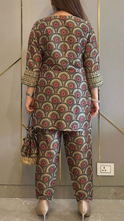 Complete flat layout presentation of the maroon designer co ord set displaying the separate printed top trousers and matching batwa bag together.