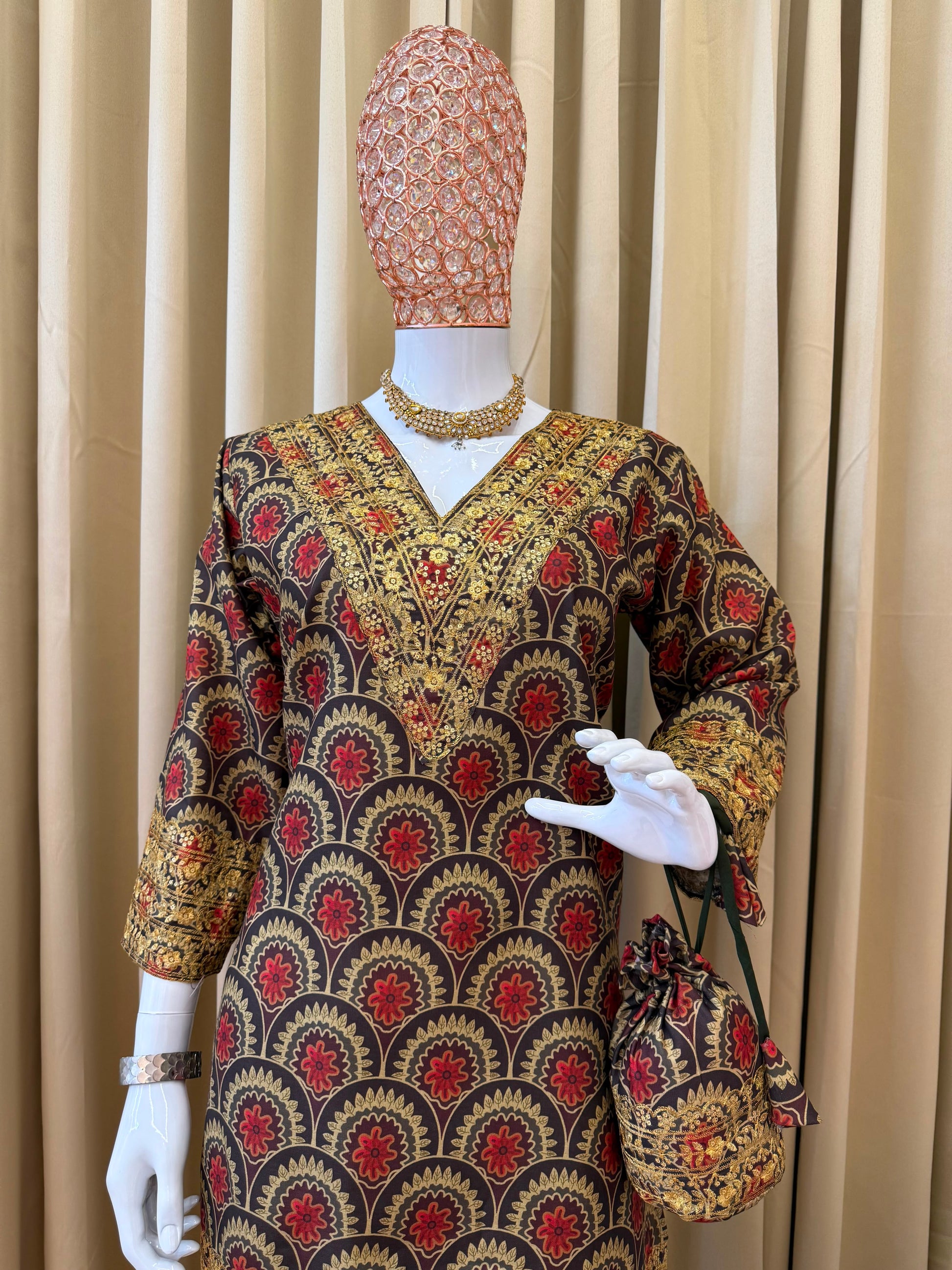Focused shot of the elegant maroon daman patta border displaying the detailed embroidery accents on the base of the short festive tunic.
