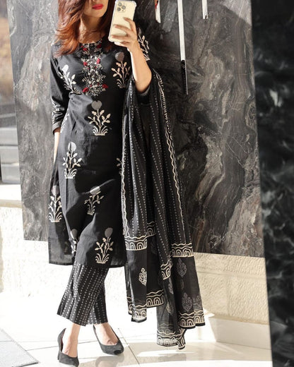 Front view of full three piece black handwork embroidered kurta set displaying a straight fit cotton tunic top trousers and a soft malmal dupatta scarf.