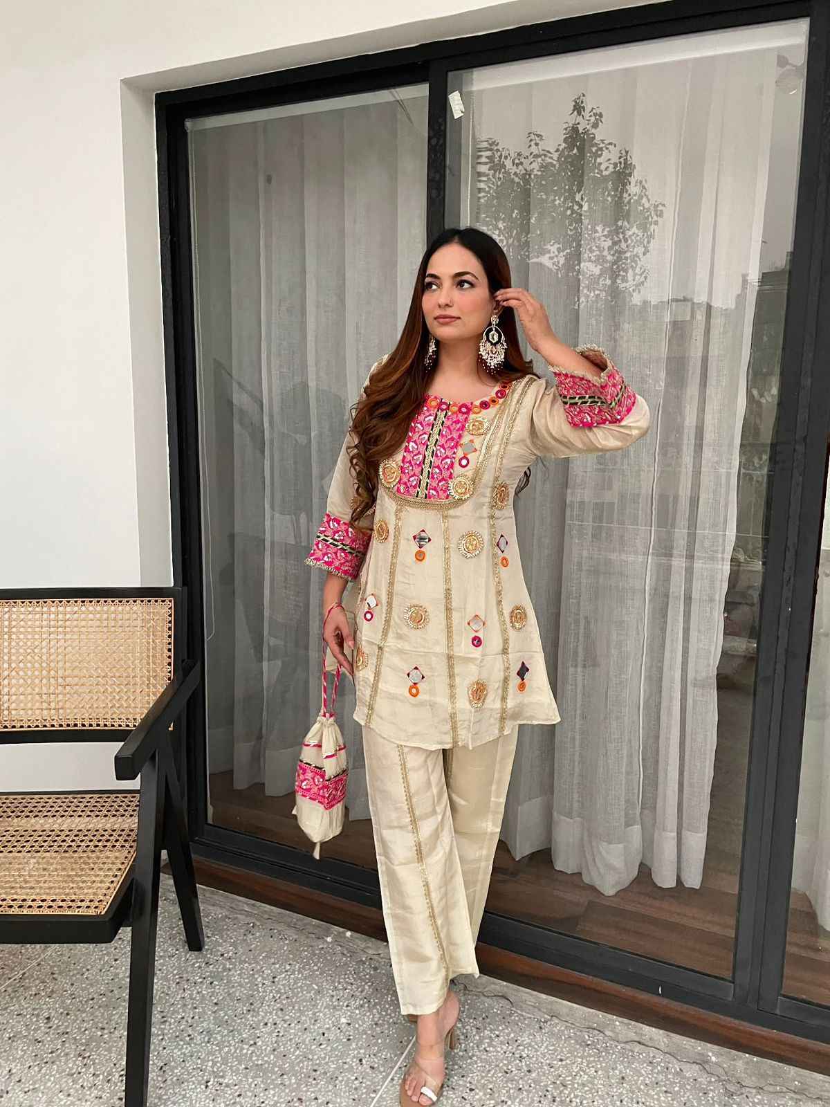 Front view of full two piece off white mirror embroidered cos moss co ord set displaying a sequence work tunic top and matching palazzo trousers.