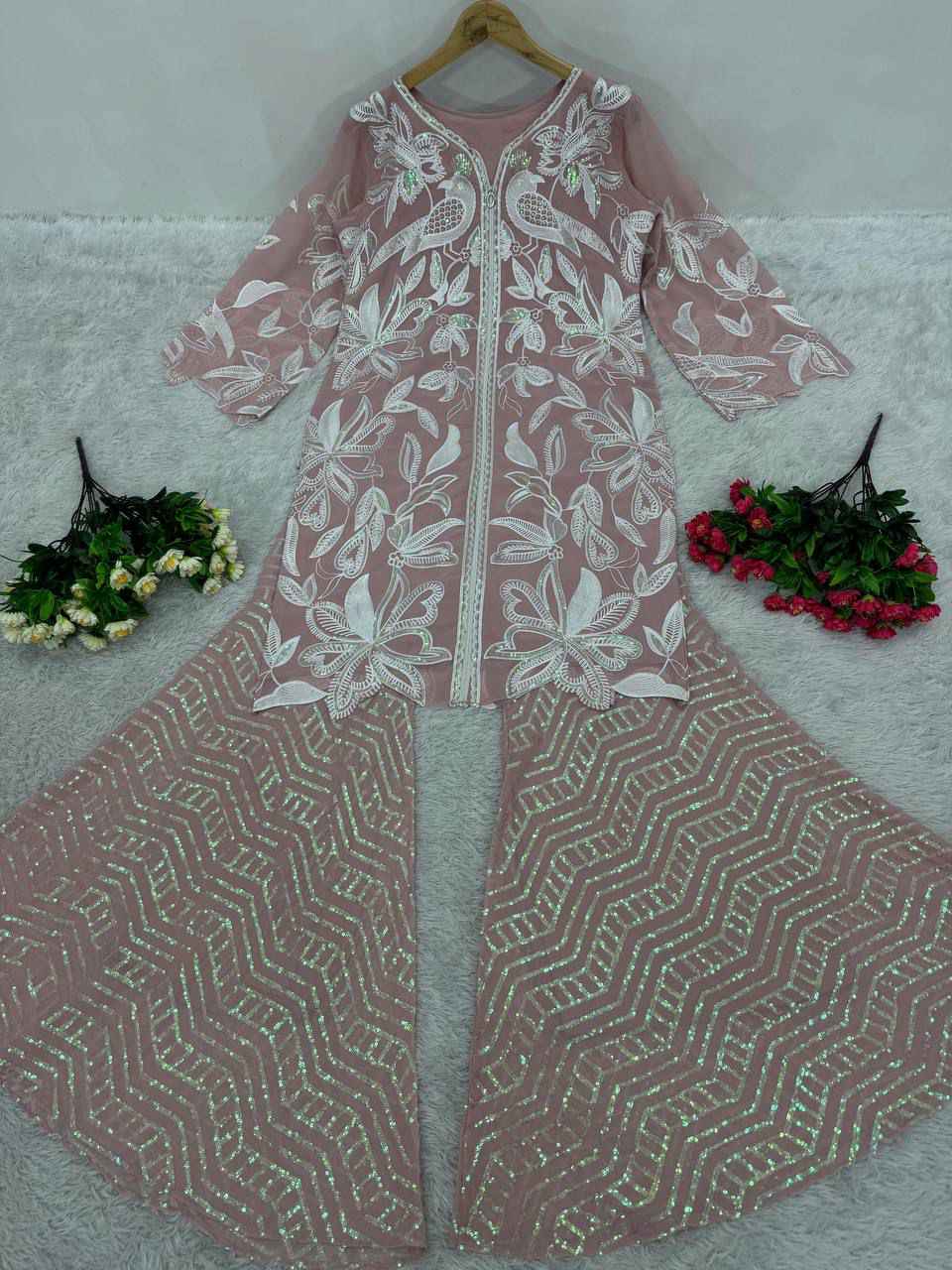 High resolution view of the dusty rose heavy faux georgette palazzo trousers displaying the full heavy embroidered sequences work from waist to hem.