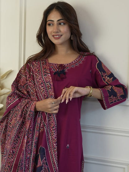 Close up view of detailed traditional neck full embroidery work and dense artisan thread patterns on a rich wine cotton kurta bodice.