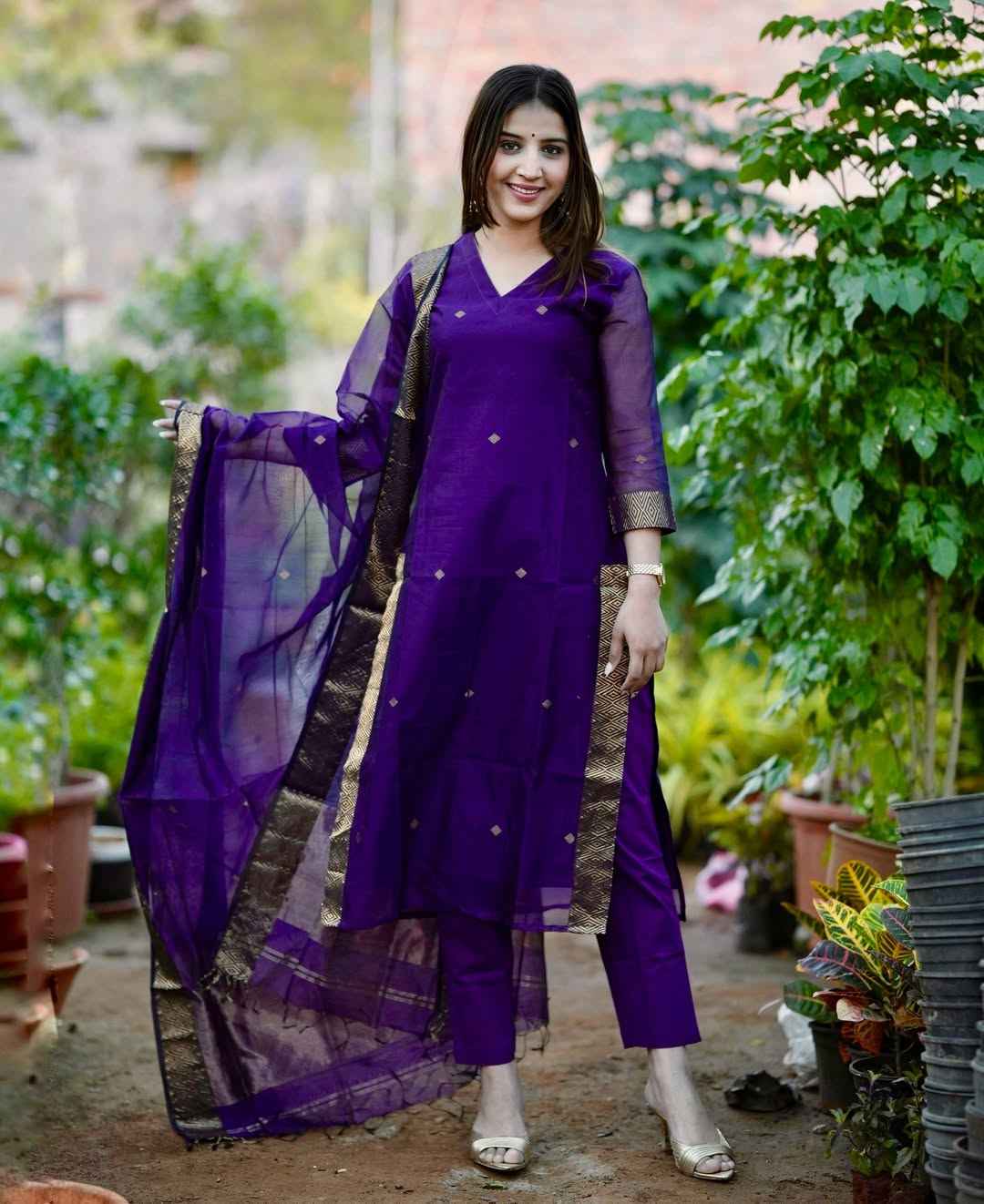 Front view of full three piece royal purple handwoven jamdani cotton suit set displaying a woven motif tunic straight trousers and a full length dupatta.