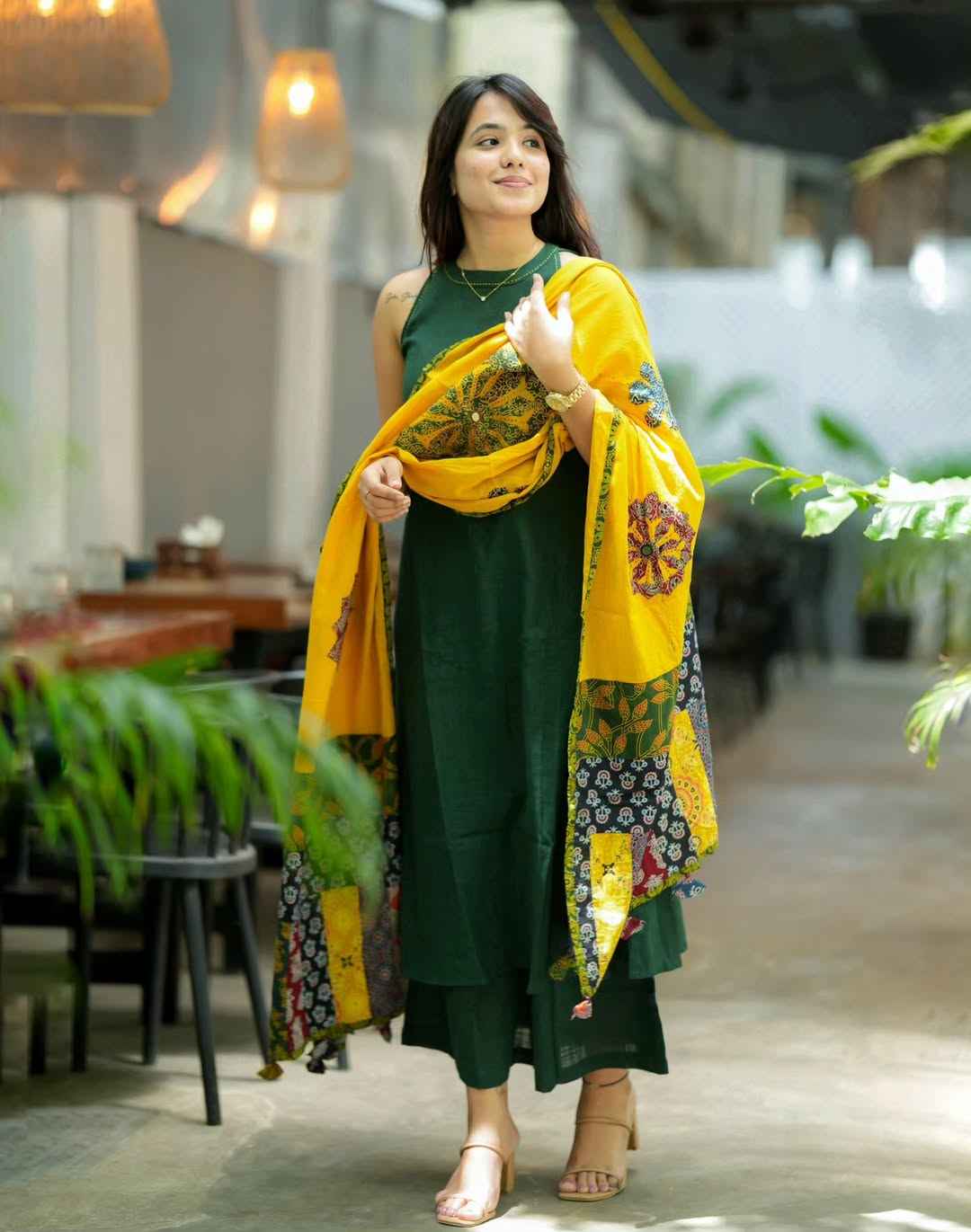 Side perspective presentation of the green a line tunic highlighting the smooth seamless lines and functional integrated side pockets on both sides.