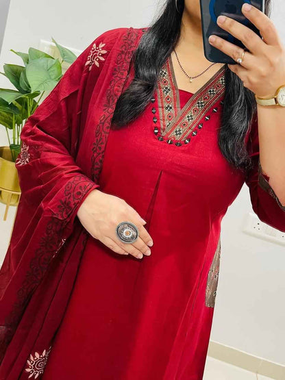 Side perspective presentation of the fully stitched red ethnic tunic highlighting the clean tailored borders and regular forty seven plus inch length outline.